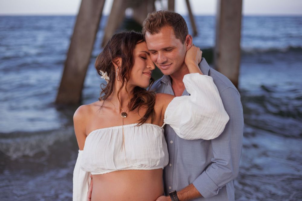 Dramatic pier shot for maternity shoot in Deerfield Beach florida, taken by wanderlust studios