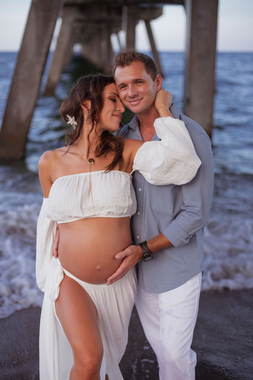 Dramatic pier shot for maternity shoot in Deerfield Beach florida, taken by wanderlust studios, with moody vibes