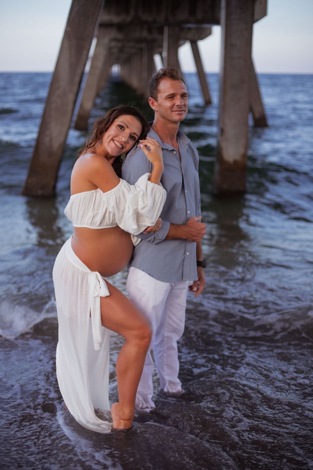 Dramatic pier shot for maternity shoot in Deerfield Beach florida, taken by wanderlust studios, with moody vibes