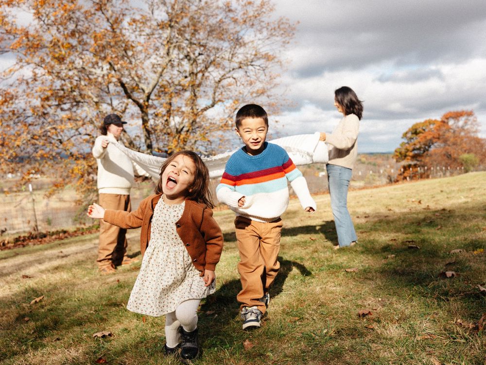 Fun and energetic outdoor family photos in an autumn landscape.