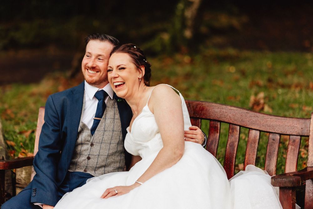 Couple laughing on bench
