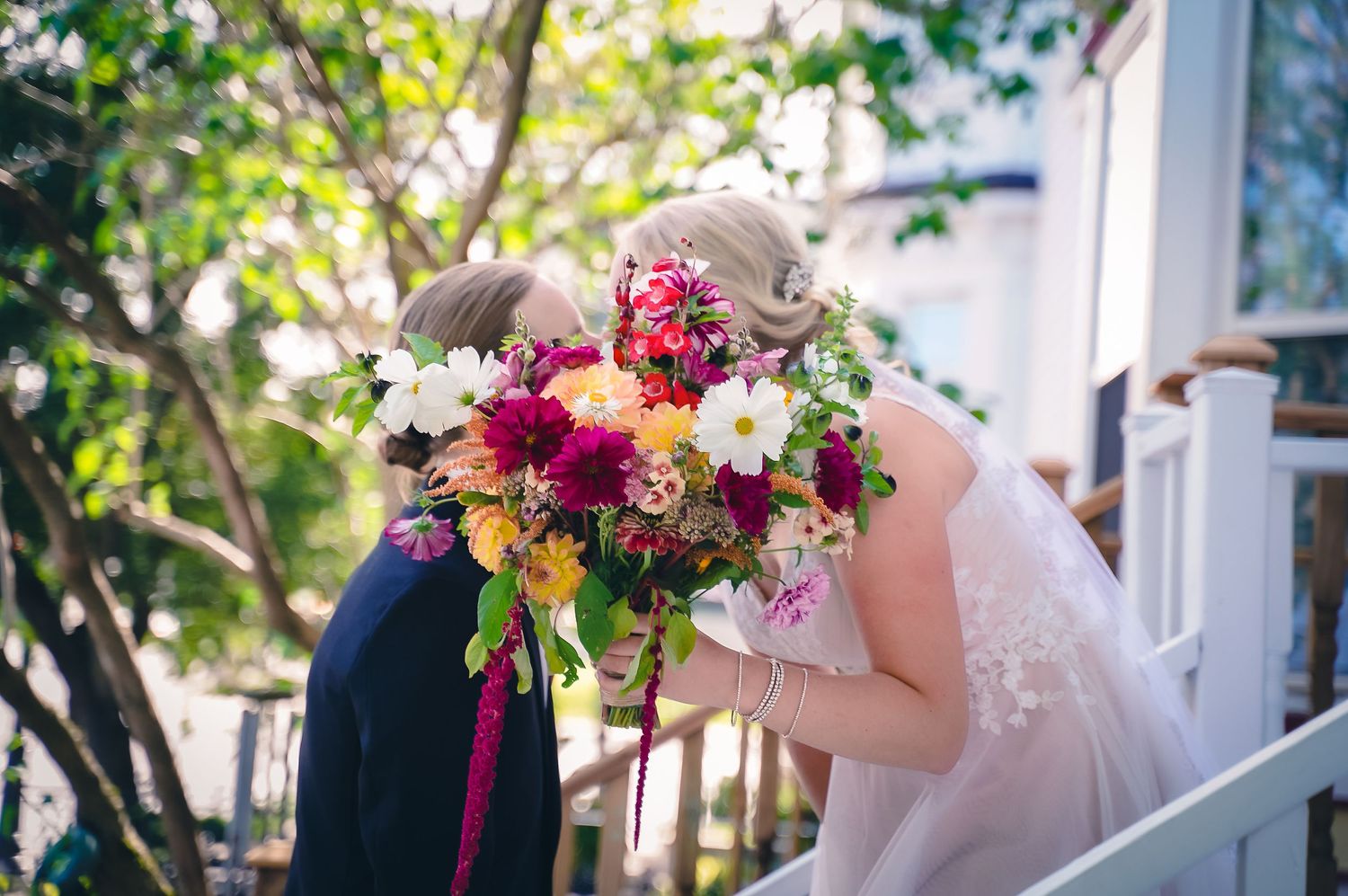 A unique first look idea with love and flowers on stairs in downtown St. John's, by the top wedding photographer