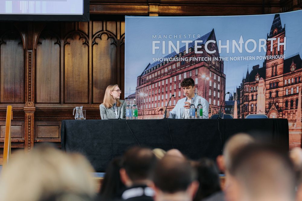 Conference stage setup showing FinTech North branding and presentation screen in historic venue.