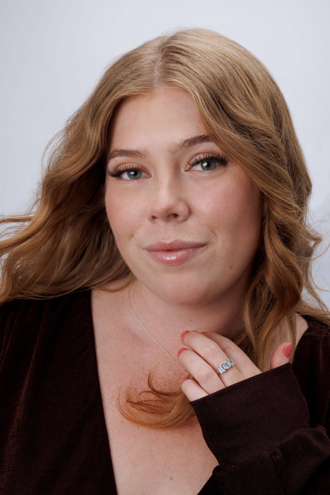 A series of five artistic portrait shots showing playful expressions against a light background.