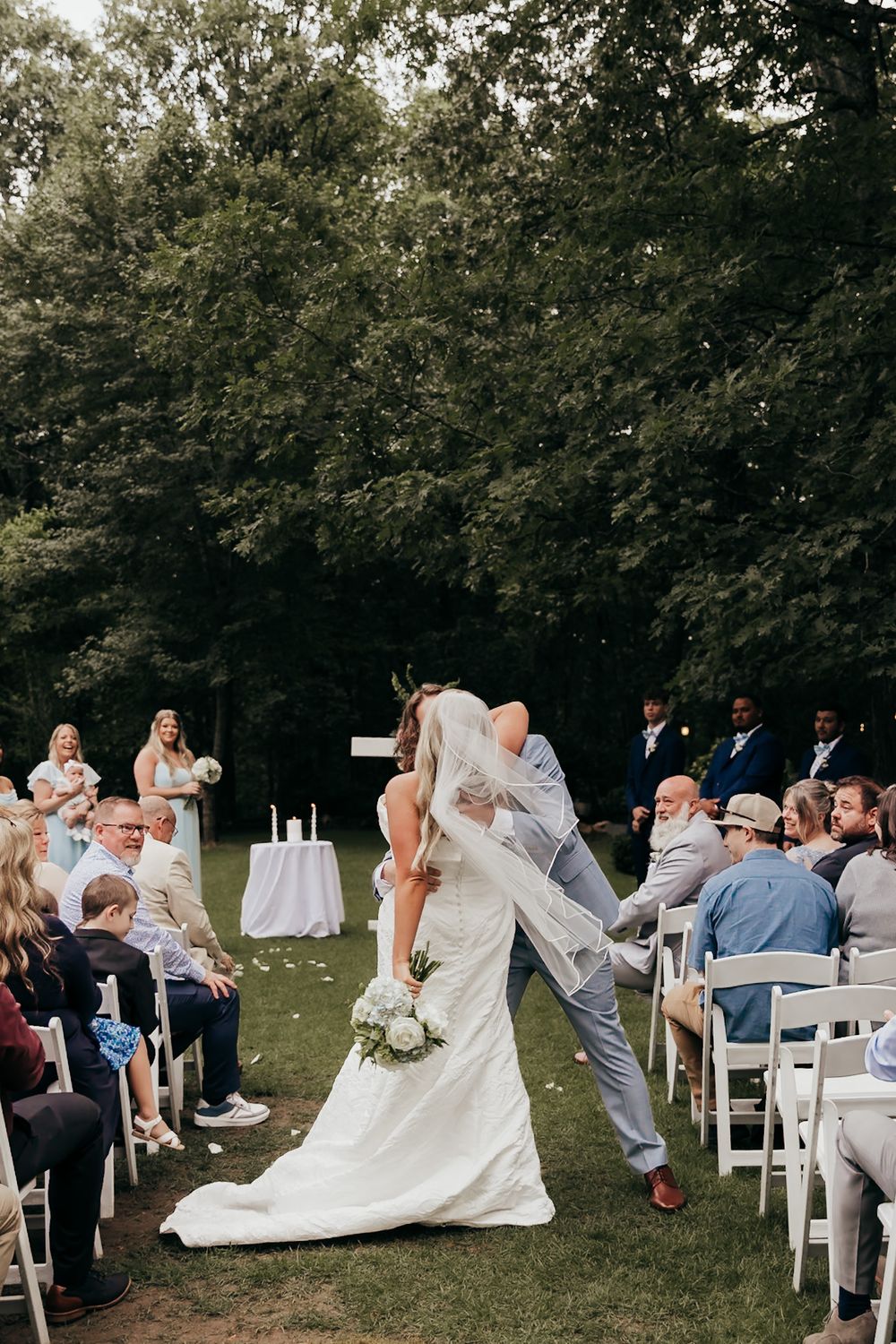 groom dipping bride at the end of the aisle after the wedding
