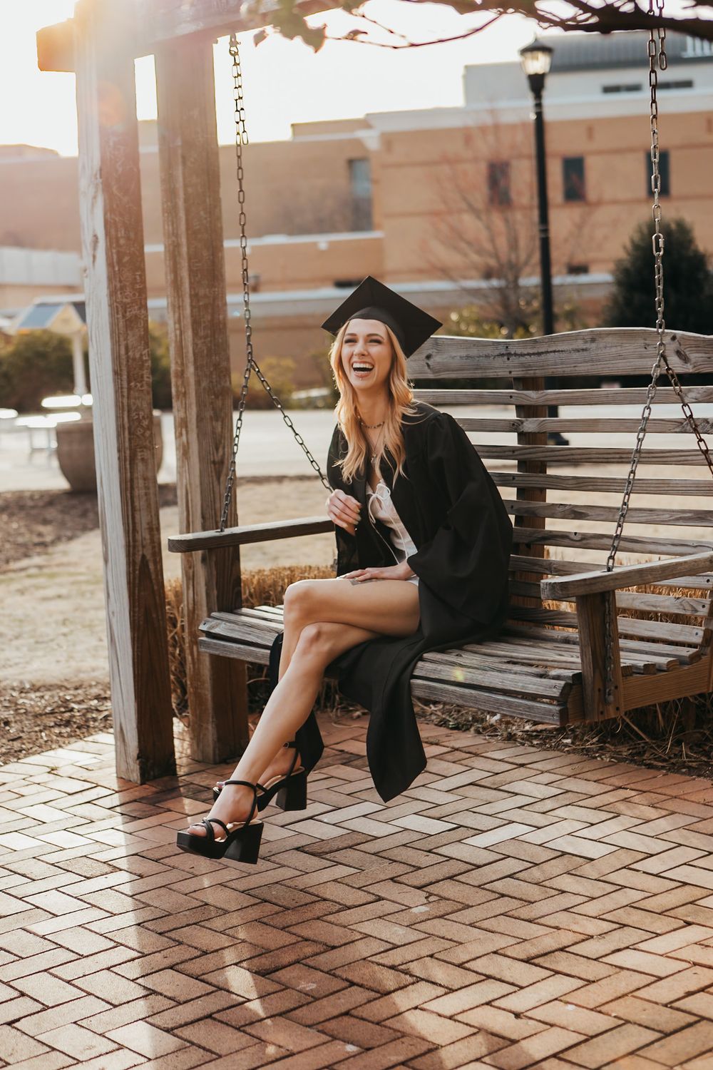 a blonde girl with her black cap and gown on at kennesaw state university