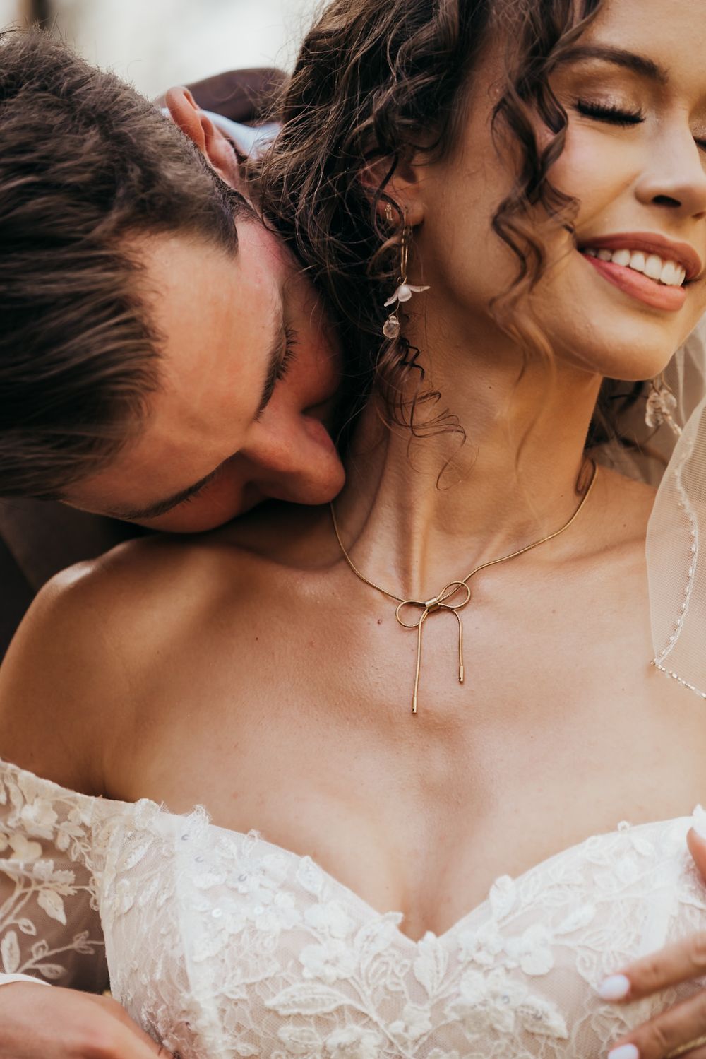 groom kissing brides neck