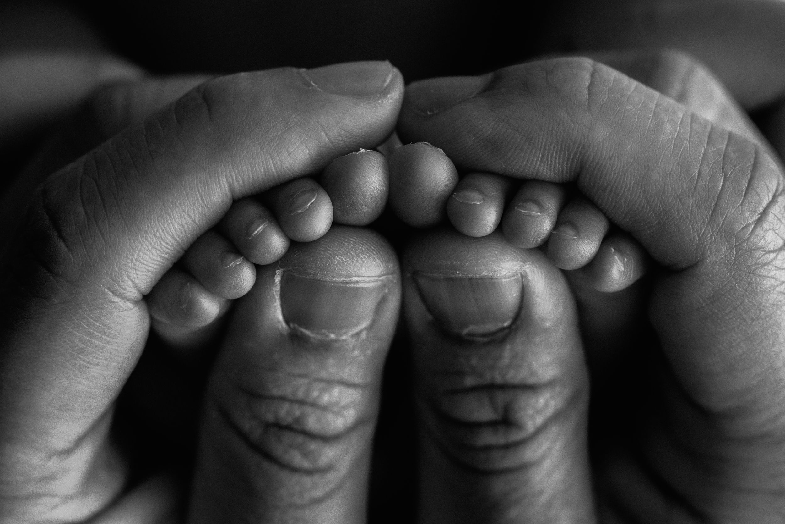 A series of black and white close-up photographs showing smiling lips and fingers in different playful poses.