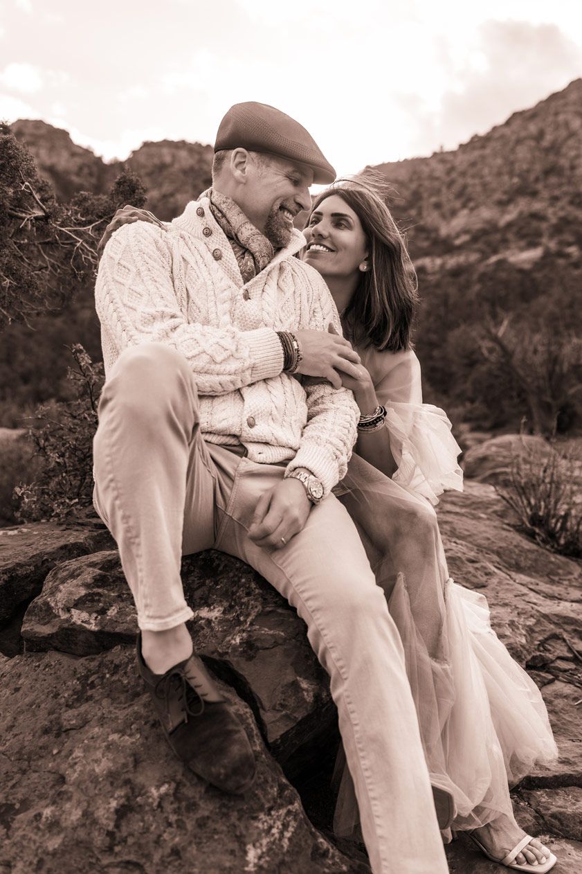 A sepia-toned romantic portrait on Sedona red rocks in the desert landscape.