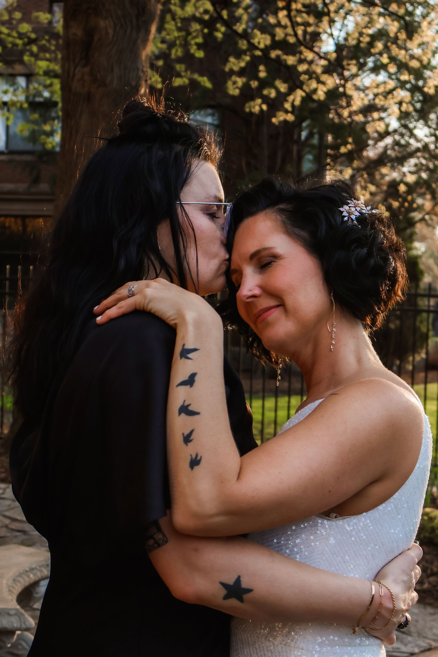 Close up of tattoo art showing flying birds on arm during wedding celebration.