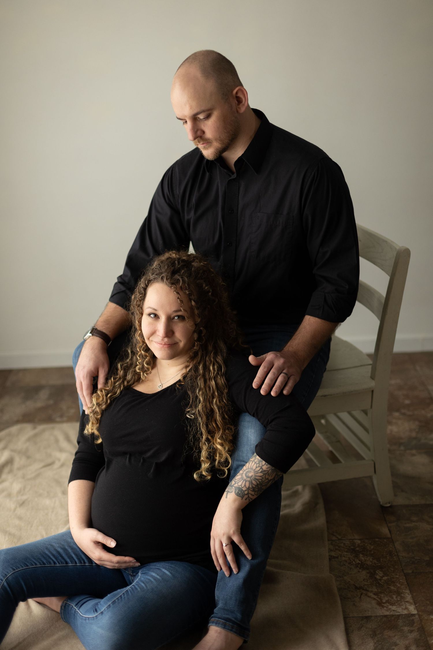 Pregnant wife poses with her husband.