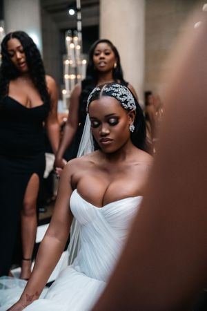 Close-up of bride wearing crystal headpiece and strapless wedding gown.