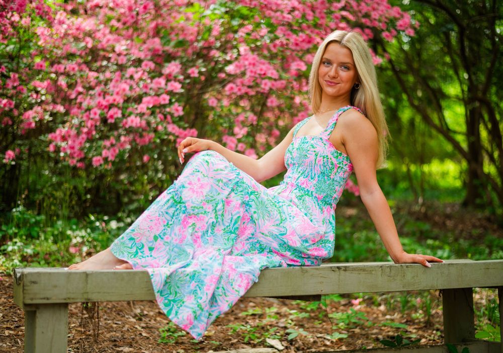 Spring portrait in floral Lilly Pulitzer dress with pink azalea blooms.