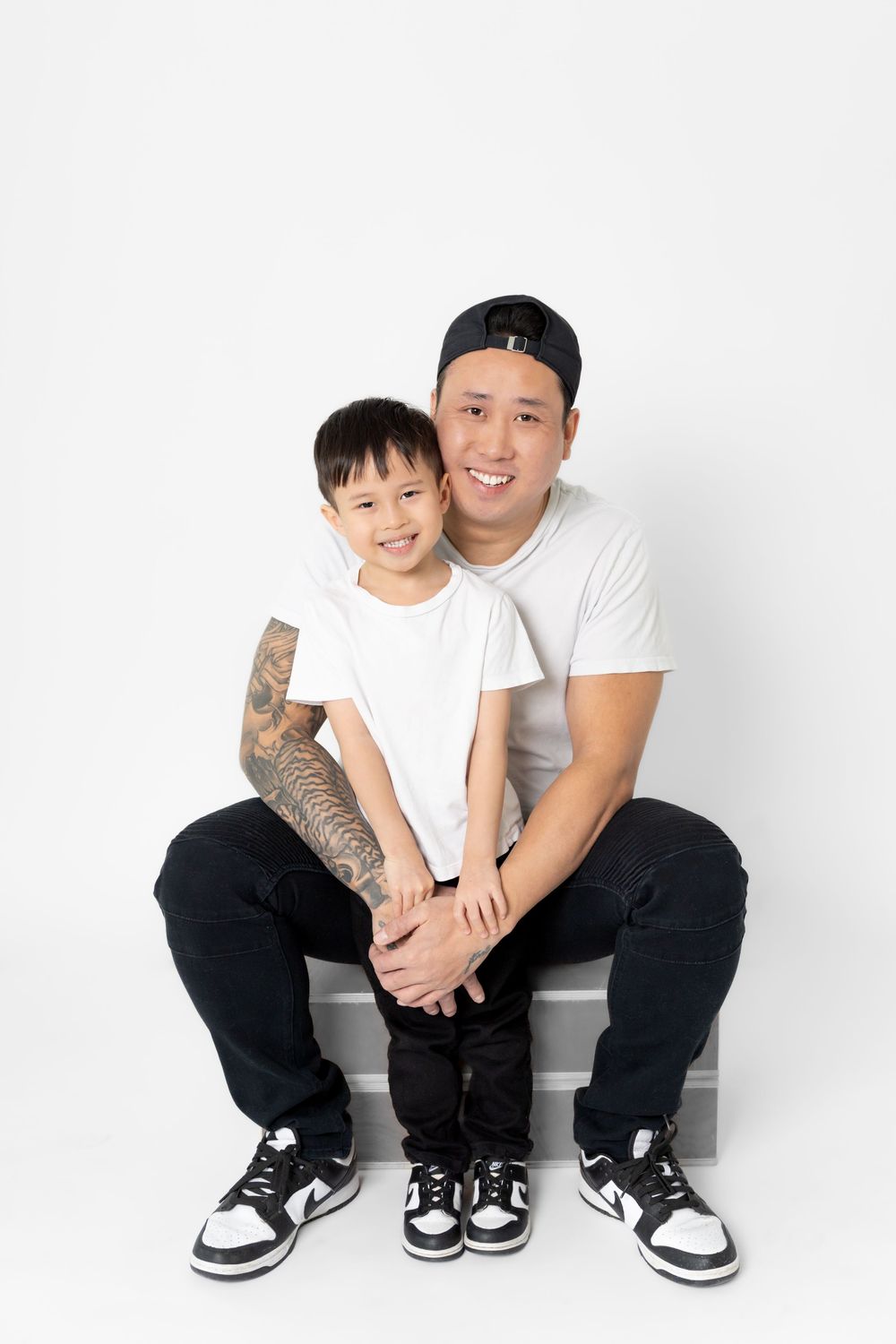 A heartwarming series of three photos showing a parent and child in matching white shirts and black pants sitting together.