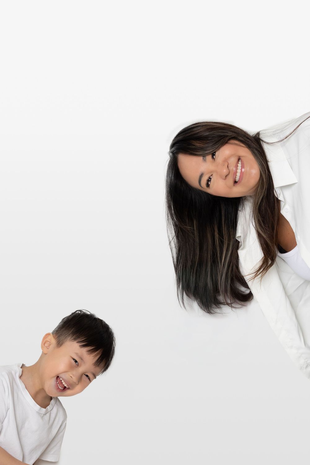 A playful moment captured against a white background showing joyful expressions and tilted poses.