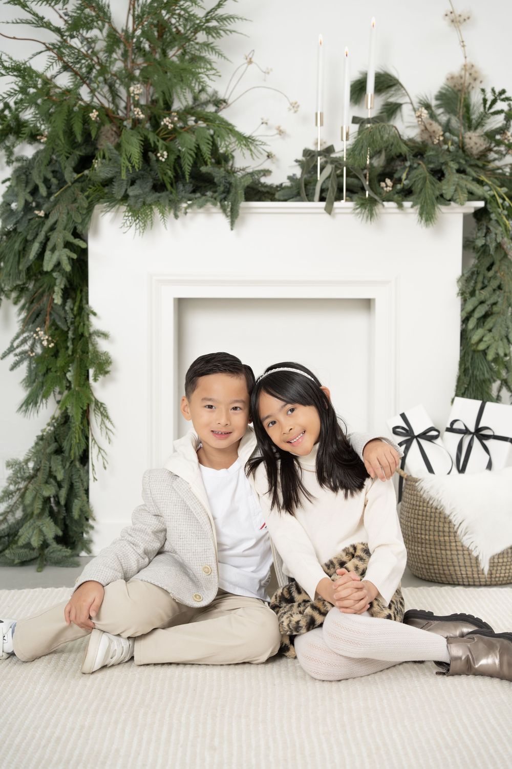 A series of holiday photos with evergreen garland decor and white backdrop showing cozy winter moments.
