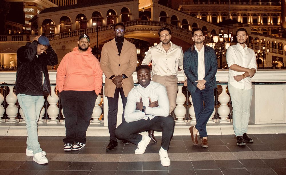 Group of seven men posing inside The Venetian Las Vegas ornate lobby interior.