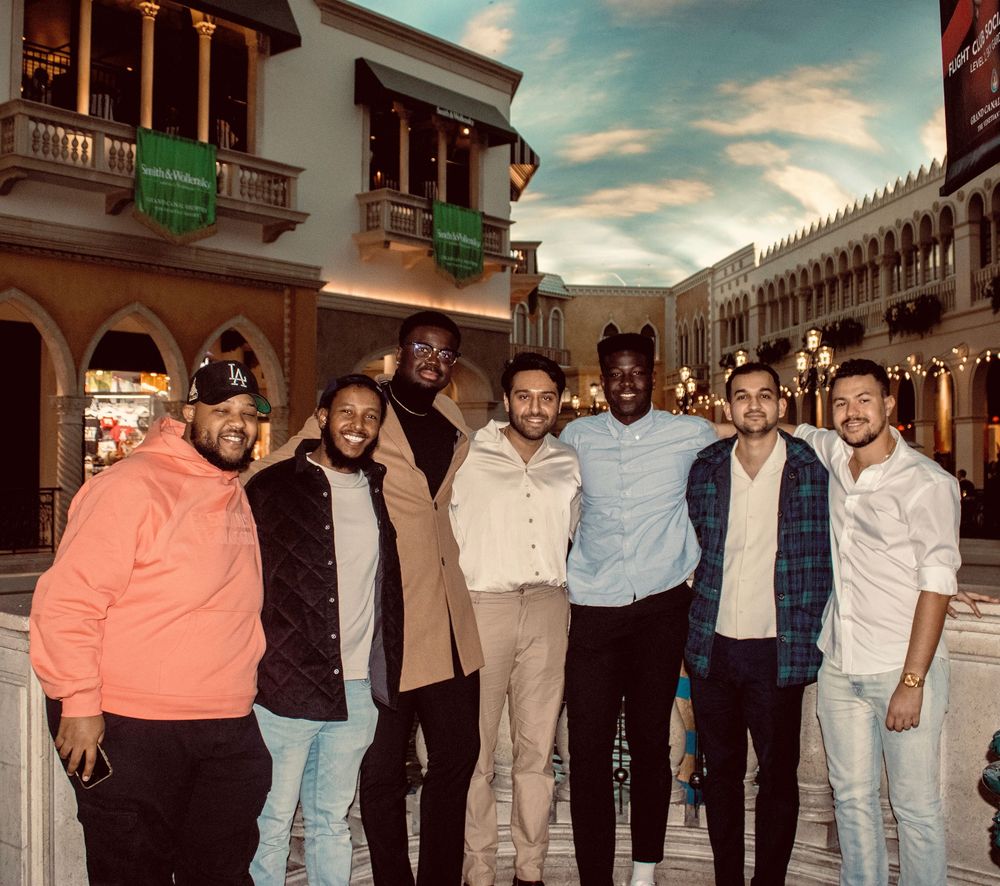 Group of seven young men posing together inside The Venetian Las Vegas resort.