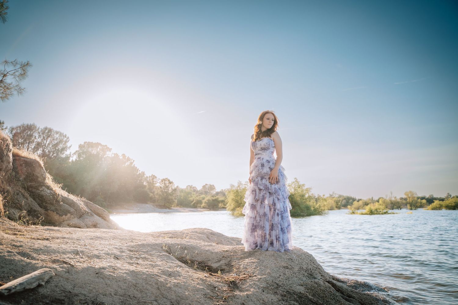 Dreamy beach photoshoot at sunset with ocean and coastal scenery.