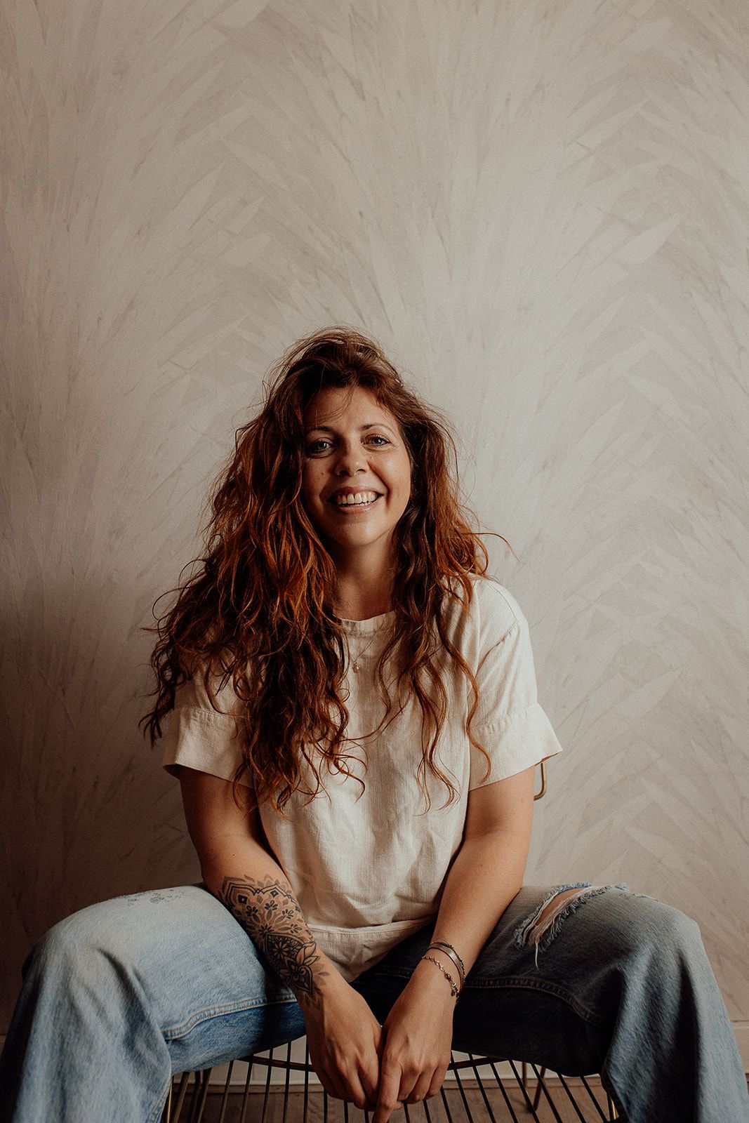 Casual lifestyle portraits showing joyful expressions and natural red hair against white textured wall.