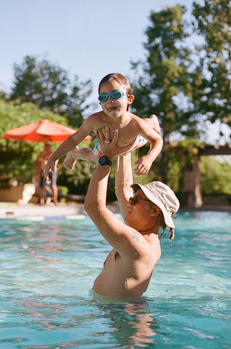 Swimming pool sequence showing playful water movements and splashing on a sunny day.