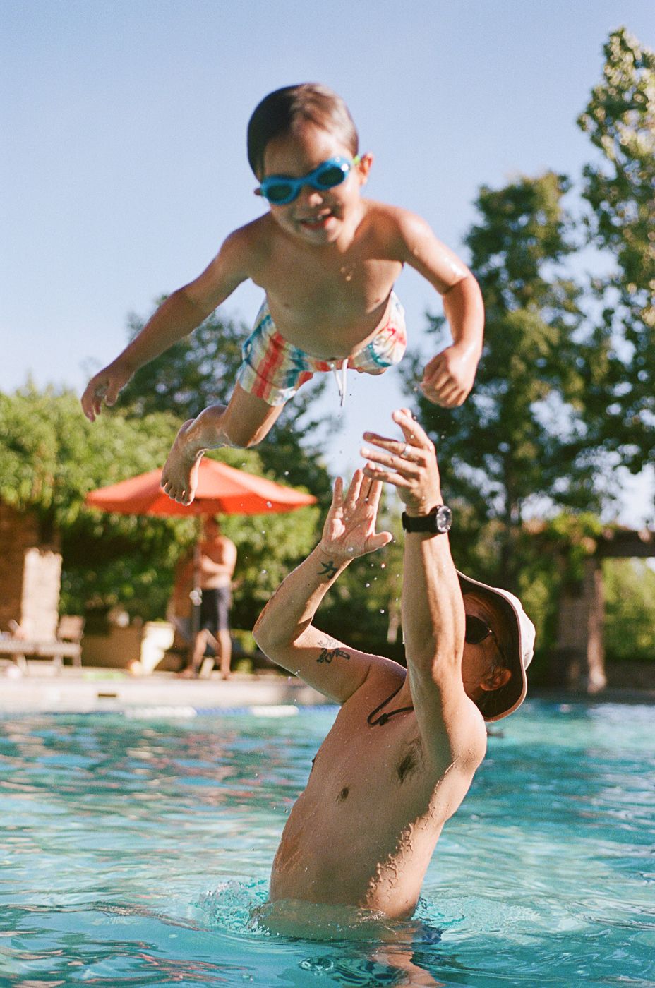 Dynamic sequence of pool play showing someone being tossed in the air above water.