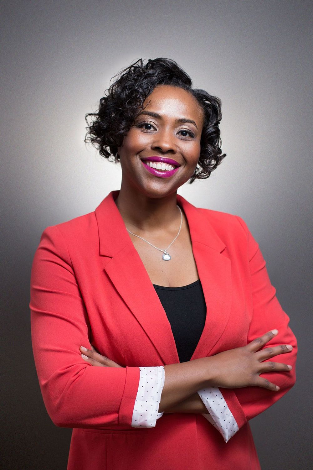 Professional female entrepreneur in red blazer with arms crossed, Atlanta studio branding headshot.