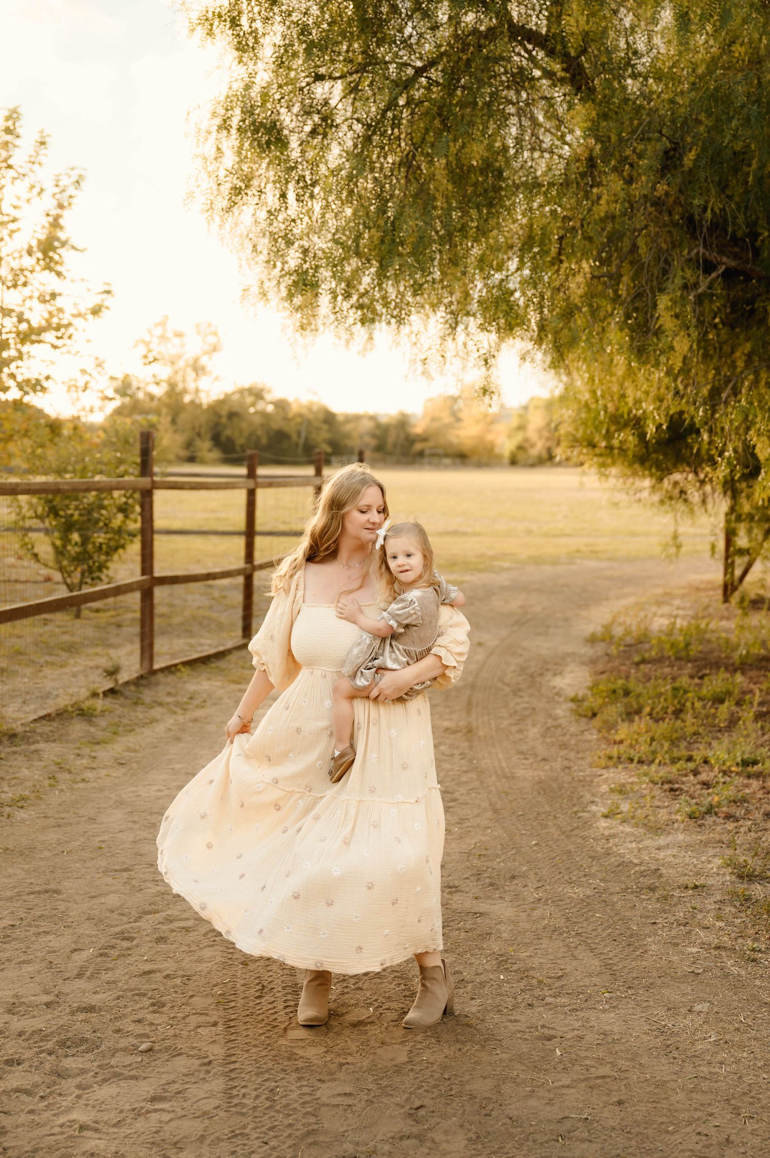 ranch mommy and me photo during family photoshoot by Ojai photographer, of woman dancing with daughter in free people dress