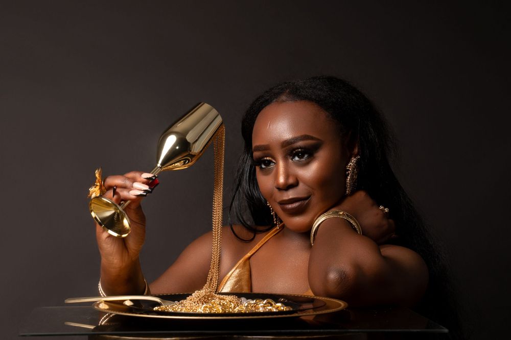 Glamorous food photography scene with gold utensils and dramatic lighting.