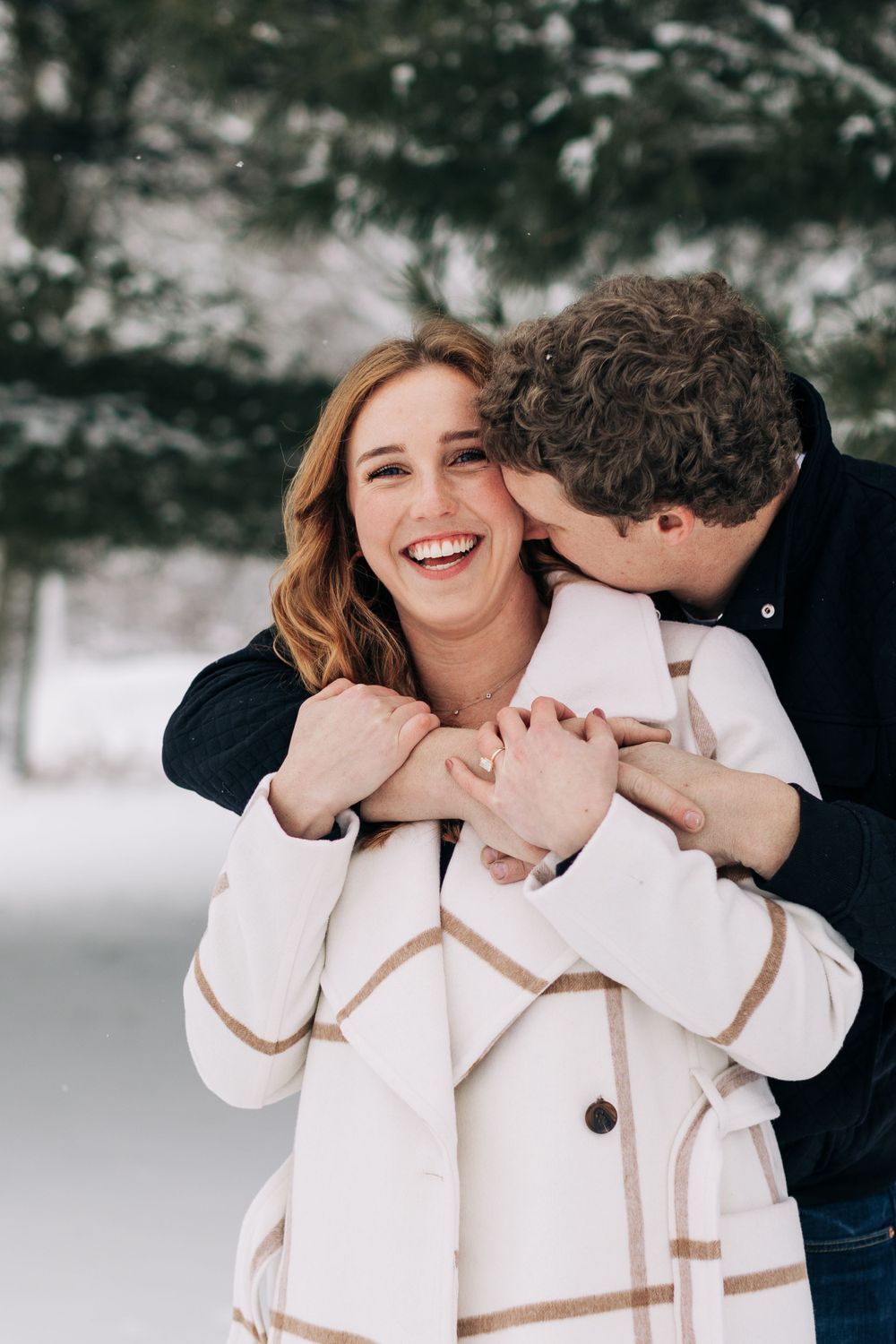 Joyful winter moment captured between couple in snow-covered setting.