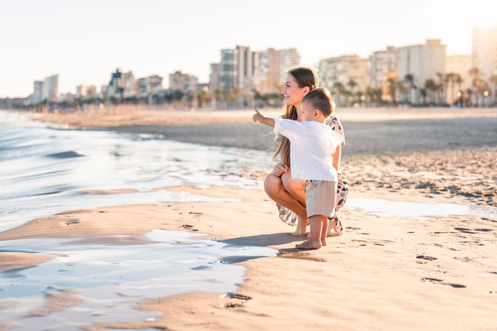 mom and son looking out a waves and pointing in Alicante