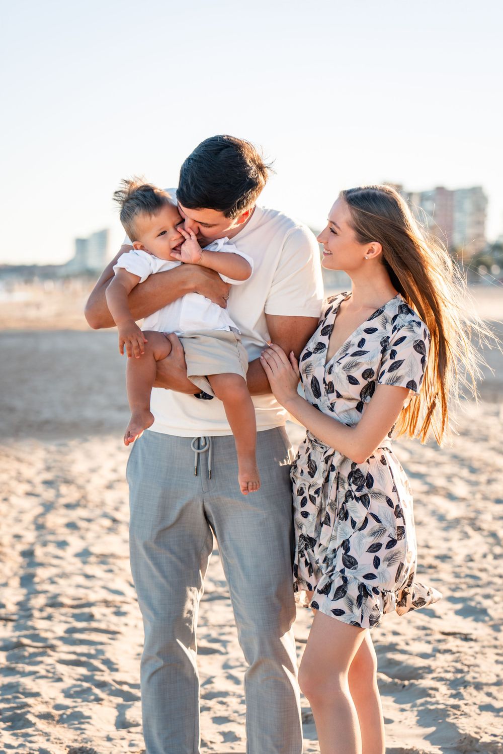 family of 3 on sandy beach Alicante Spain at sunset golden hour