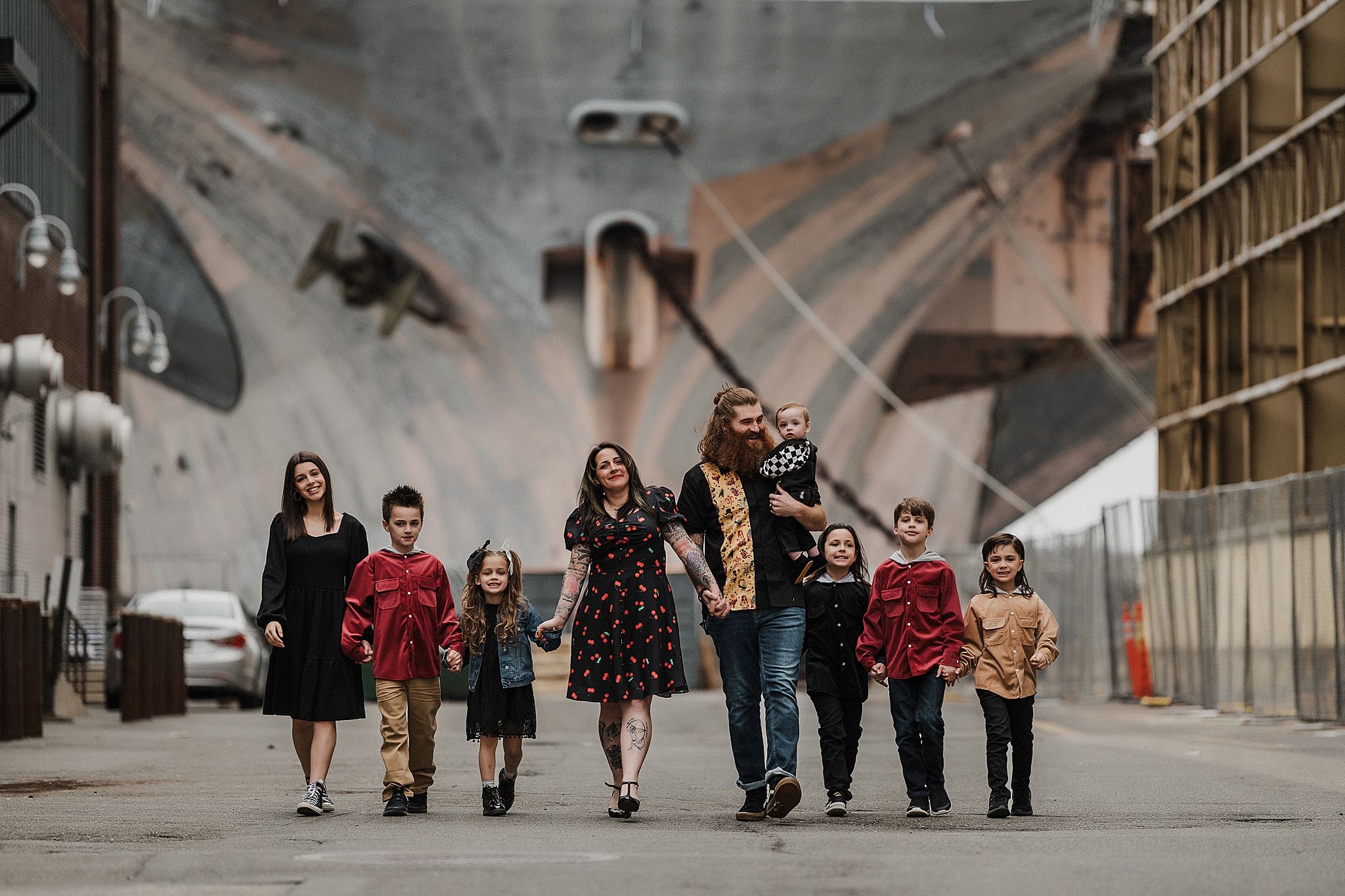 Group walking together through an industrial urban setting with geometric architecture.