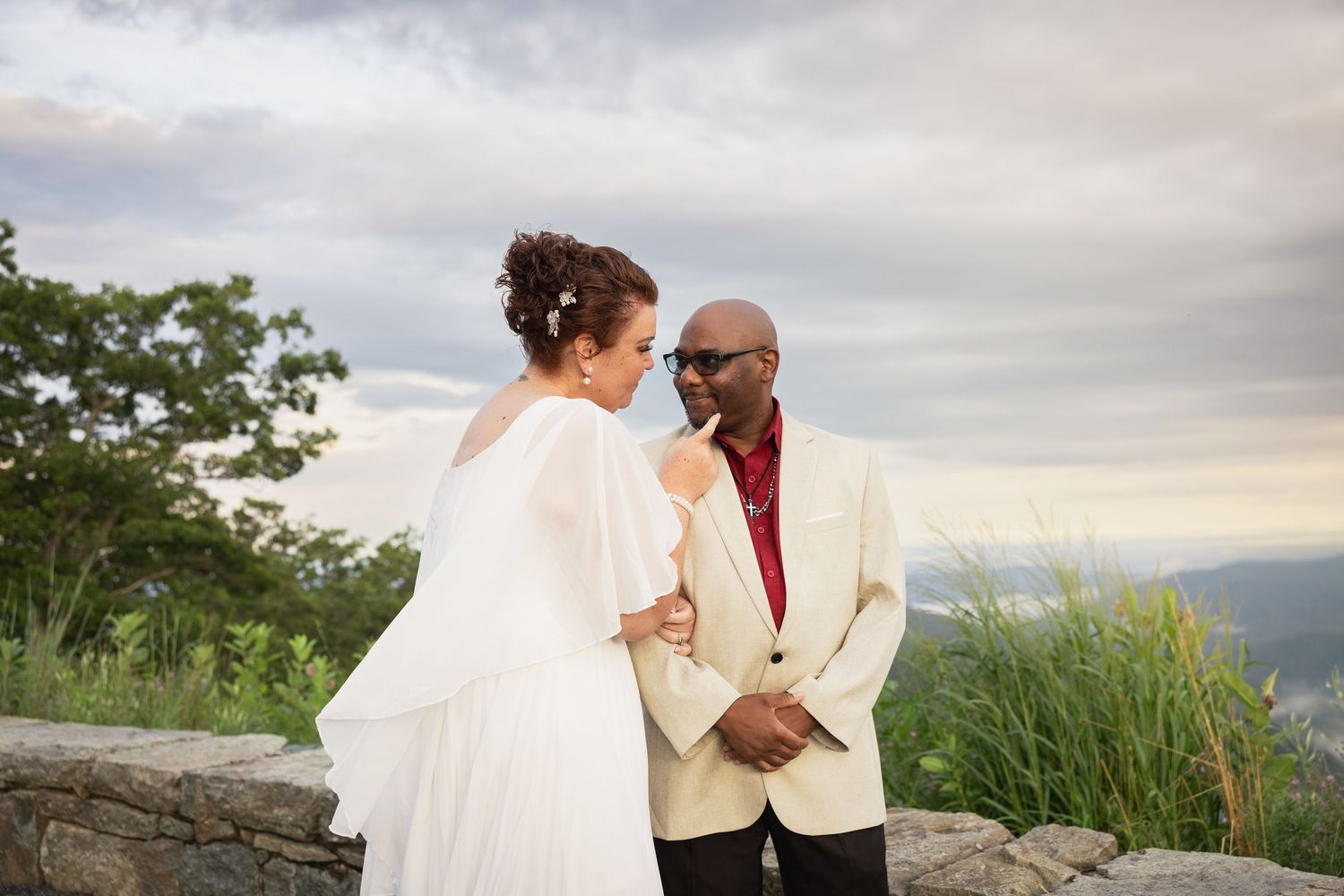 Wedding couple outdoors during golden hour sunset at an overlook in Shenandoah National Park.