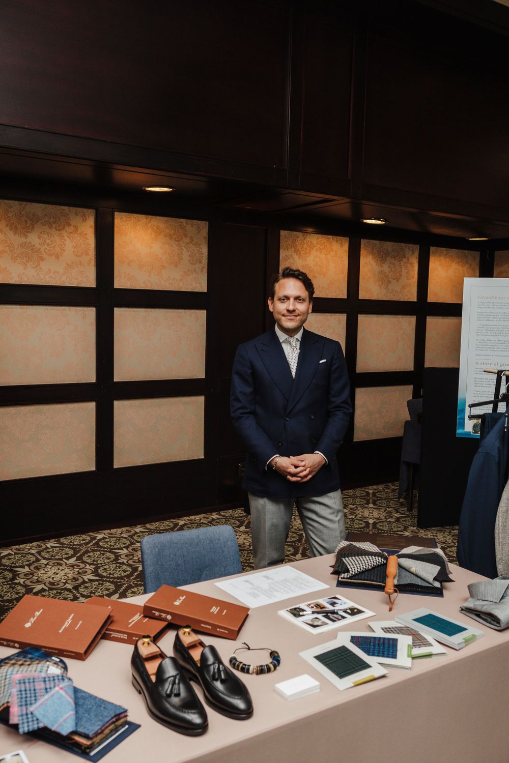Business display setup showing leather goods and electronic devices on a table.