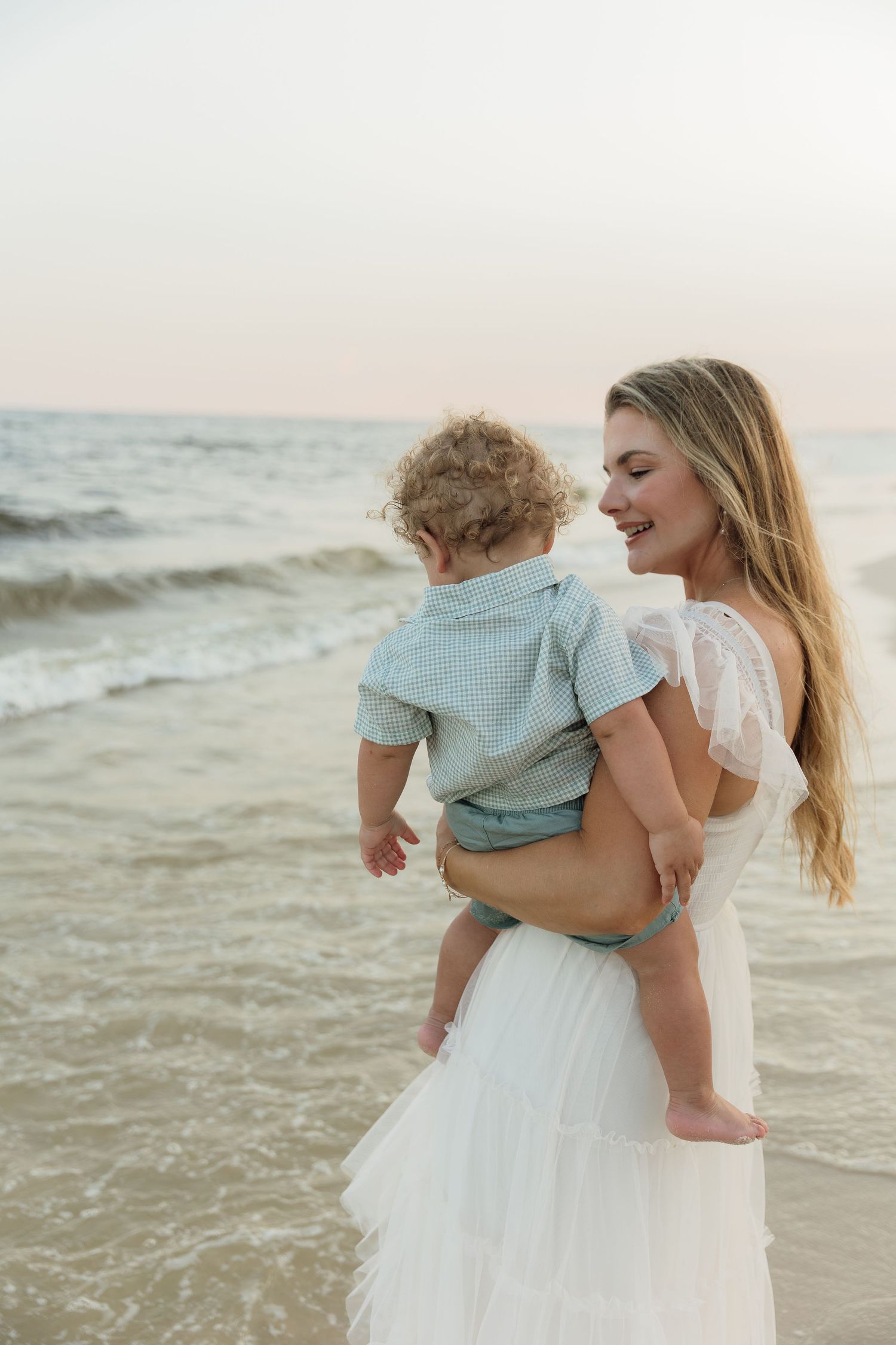 lifestyle photography of a family cuddling on a blanket outdoors