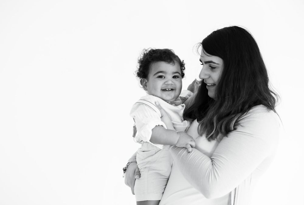 Joyful black and white portrait of parent and child sharing happy moment.
