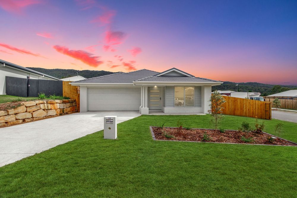 Contemporary home photographed at dusk with fresh landscaping, showcased for real estate marketing and property listings.