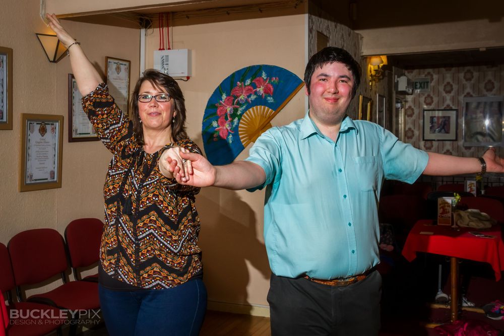 Dancers twirl and spin during a lively practice session in a community dance hall.