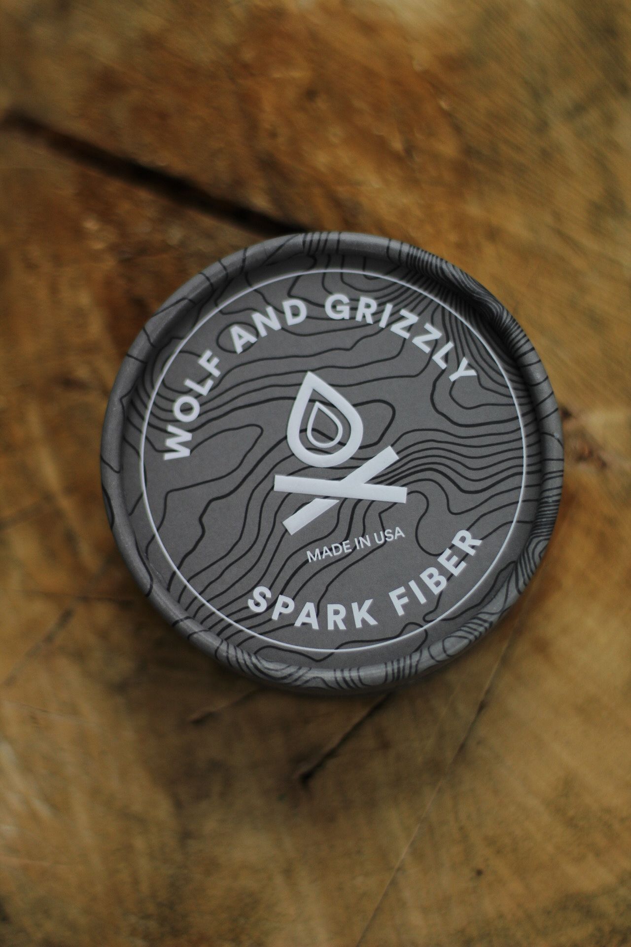 Wolf and Grizzly Spark Fiber container lid with topographic pattern design.