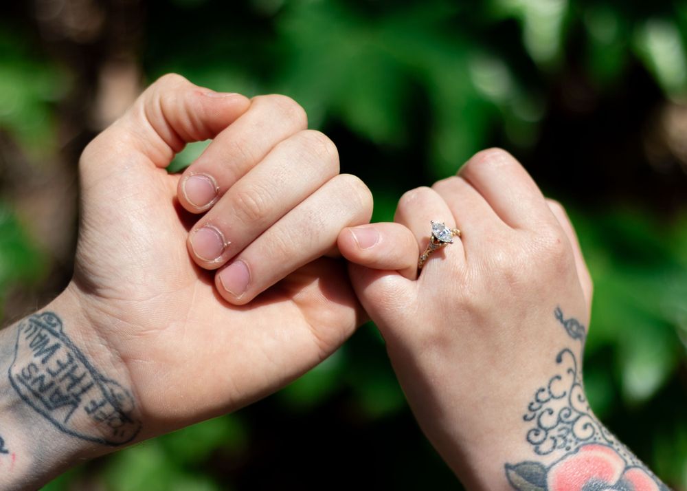 Close-up of tattooed hands with various artistic designs.