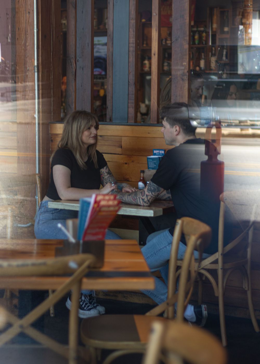 Interior cafe scene with wooden furniture and natural lighting.