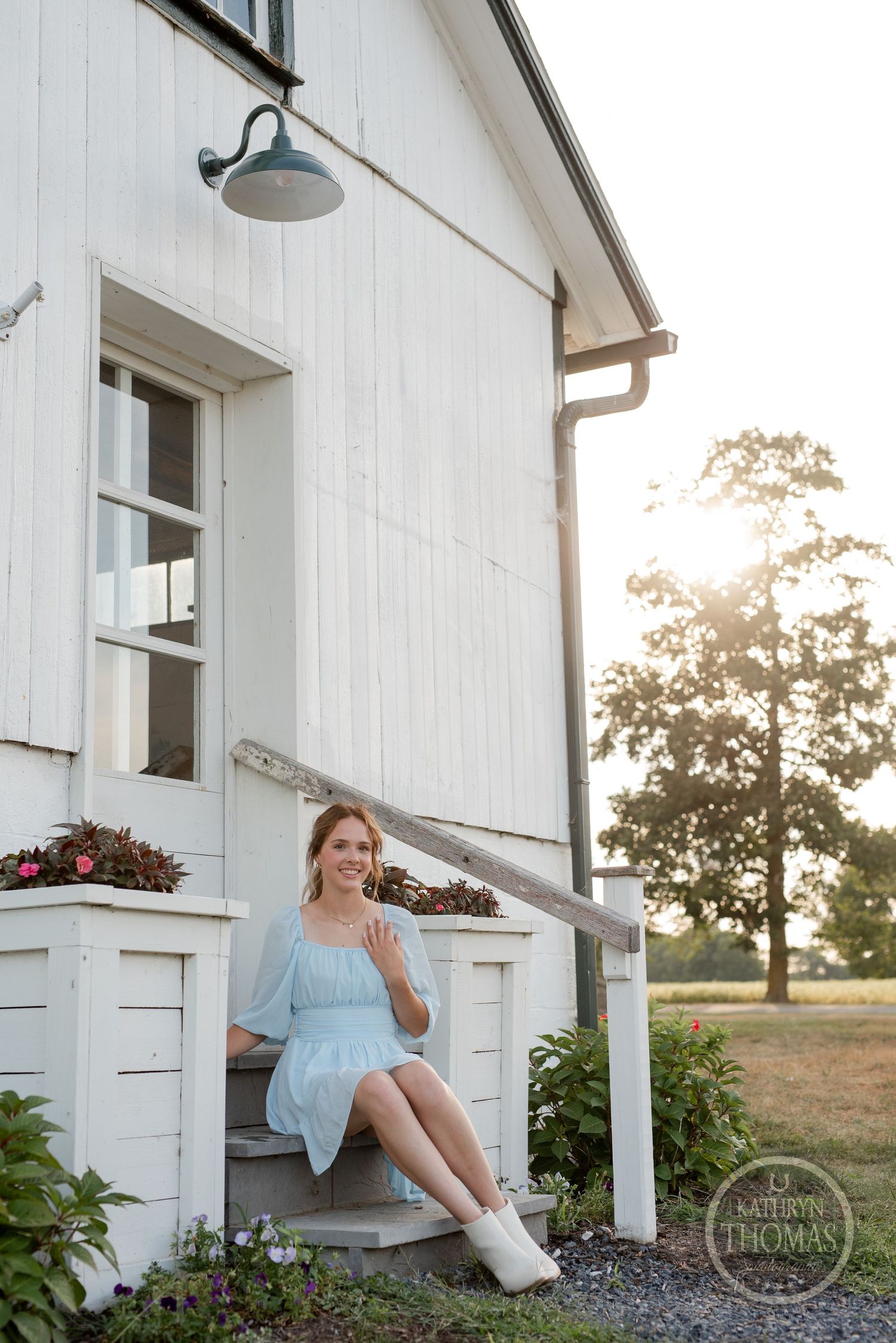 A dreamy summer evening portrait on white farmhouse steps with vintage charm.