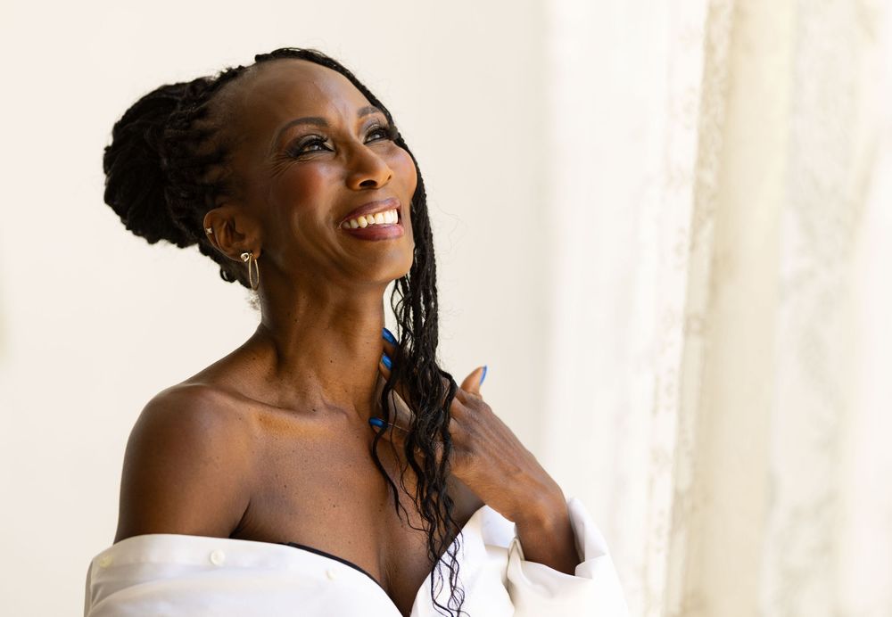 Smiling woman in photo during session with Los Angeles boudoir photographer.