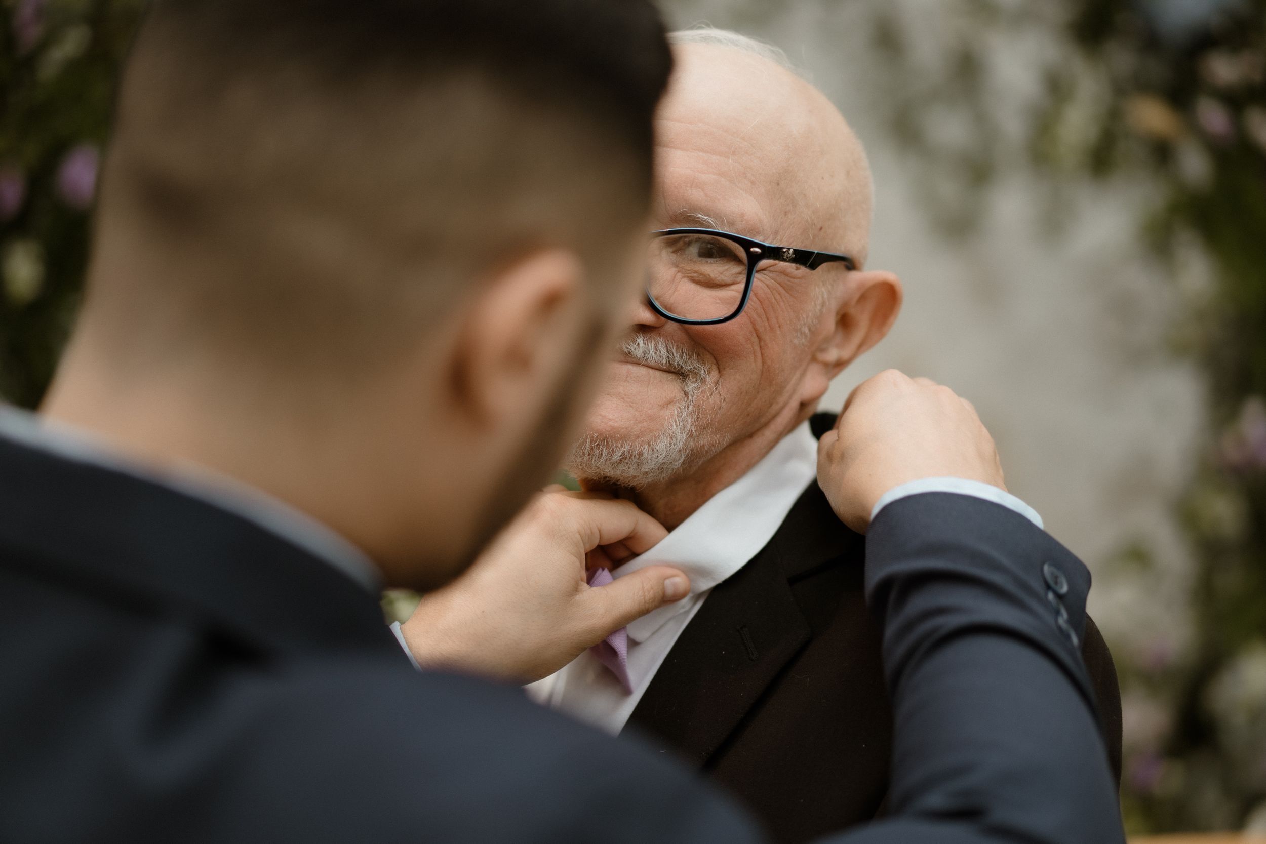 Emotional moment shared between two formally dressed people during wedding celebration.