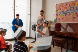 Learning environment with students and tables in front of colorful decorated walls.
