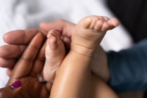 Series of close-up shots showing infant feet and hands.