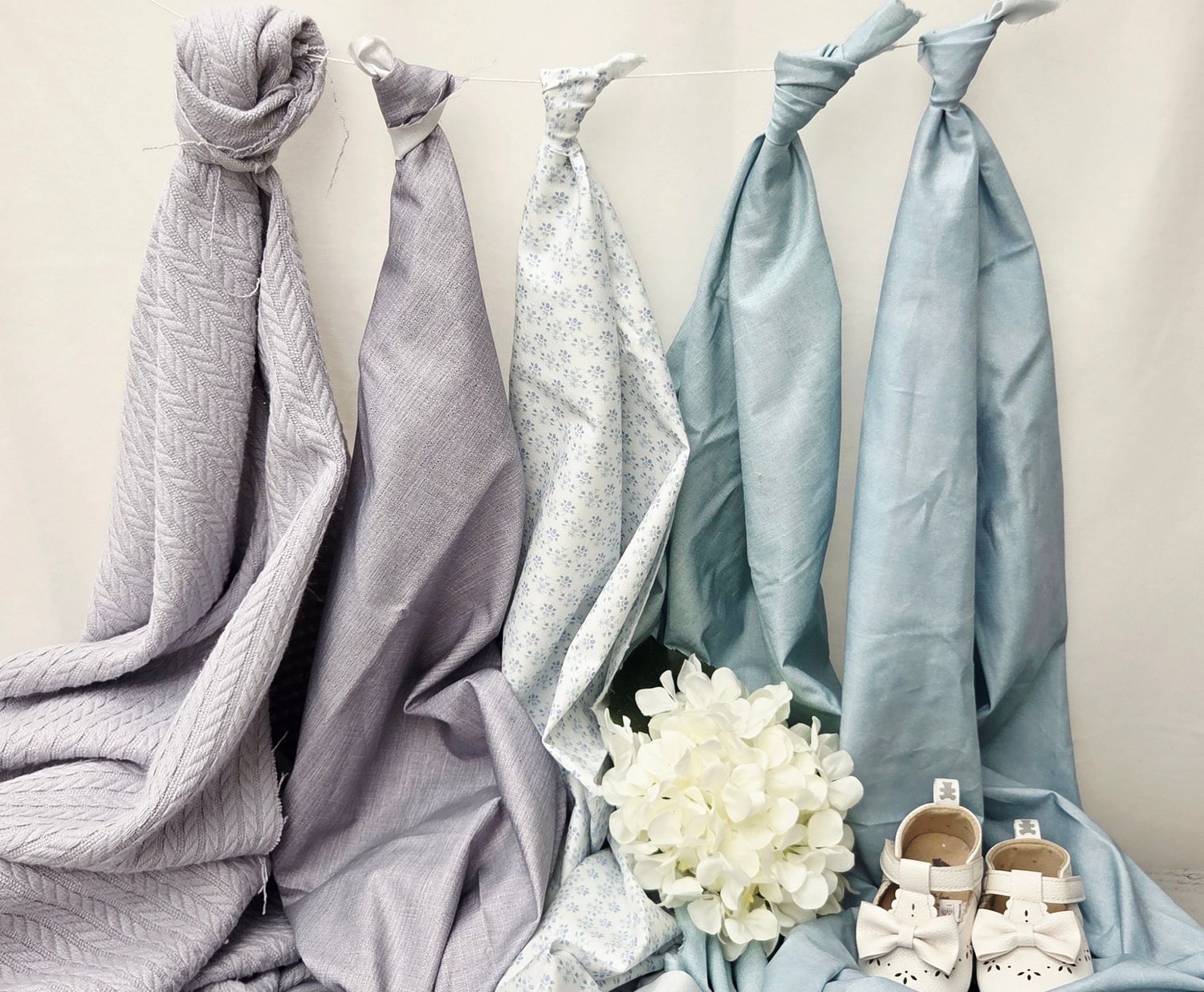 Pink floral print fabric displayed on mint green textured background.