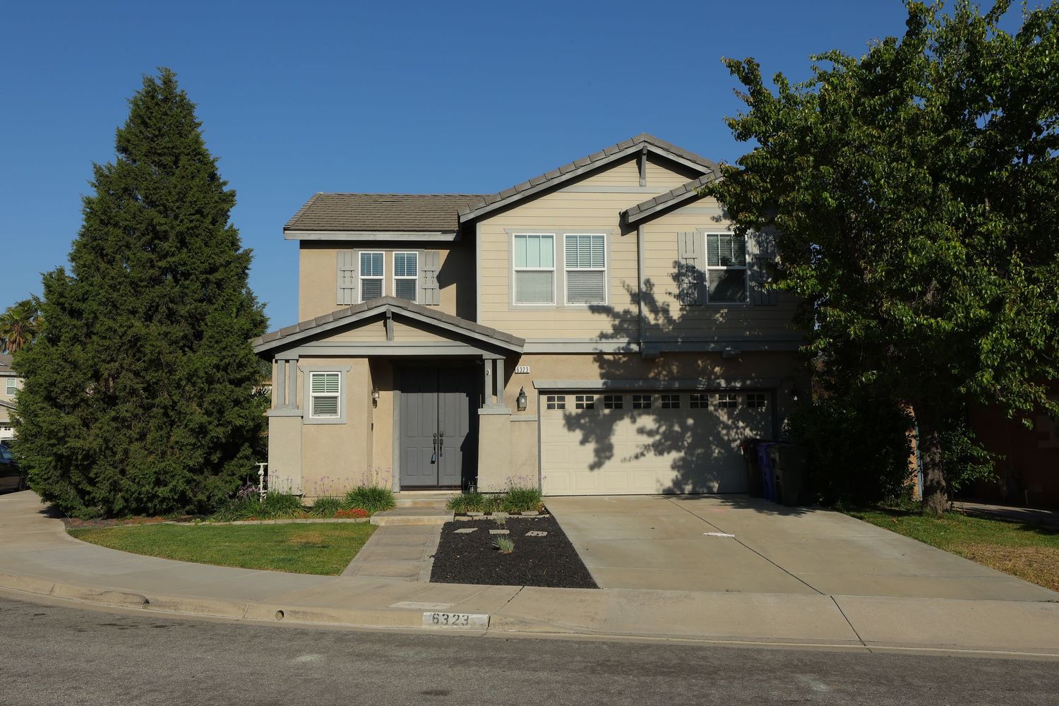 Modern two-story suburban home with grey exterior and attached garage.