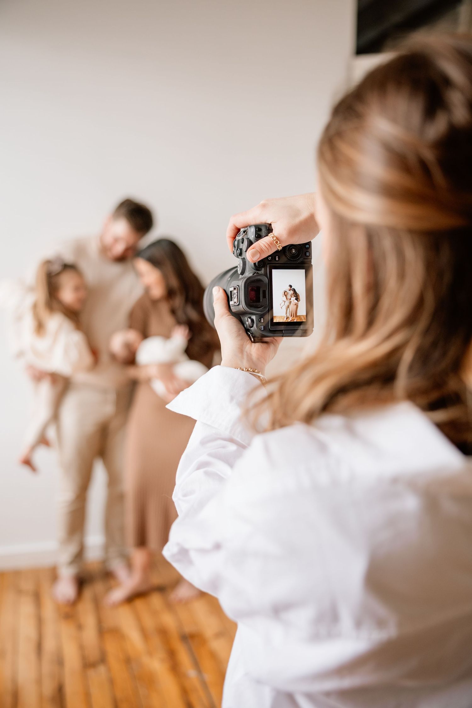 A series of five blurred photos showing someone in a white top using a camera against a neutral background.